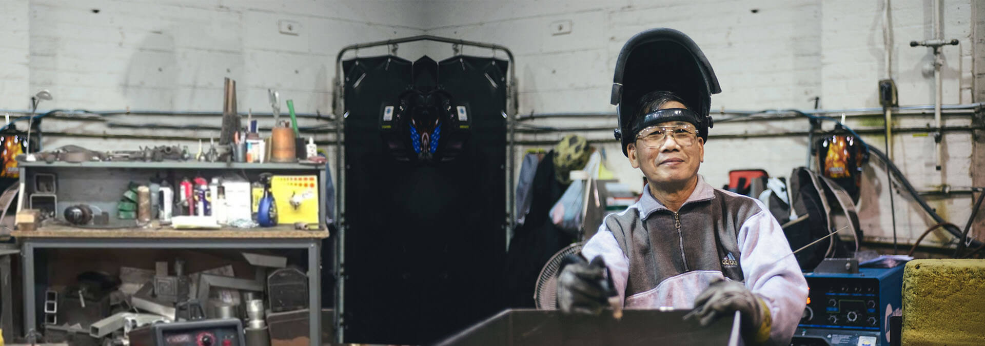An employee in full welding gear.