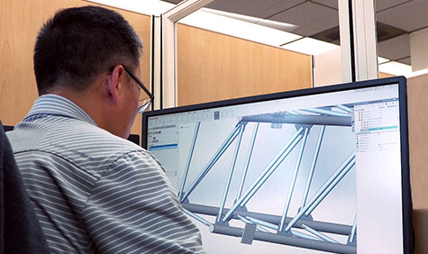 A man sitting in front of his computer monitor.